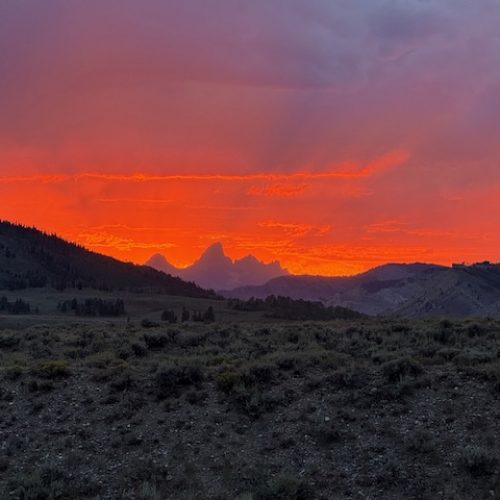 dramatic sunset over rugged mountain wilderness landscape