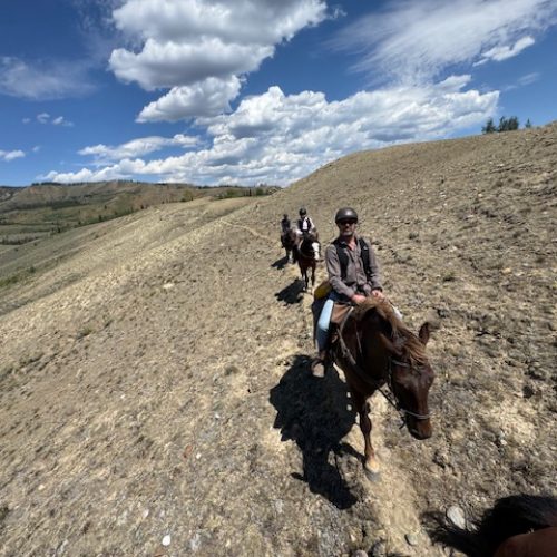 horseback riding adventure across open mountain plains
