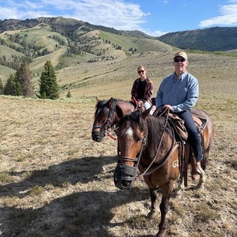 horseback riders exploring mountain wilderness trail together